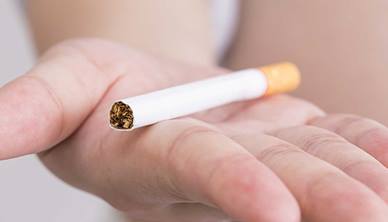 Person holding cigarette 