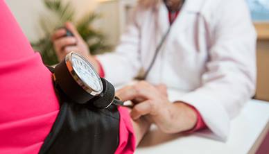 GP taking patients blood pressure