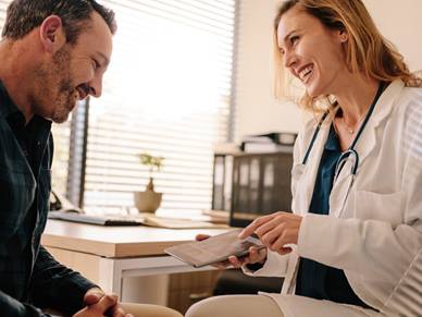 Doctor showing patient tablet device