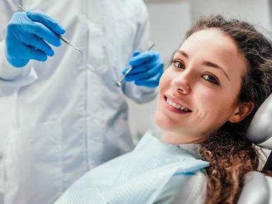 A woman is at the dentist getting her teeth checked
