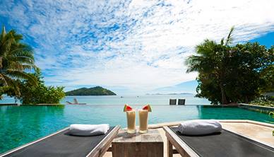 Sun beds next to hotel swimming pool