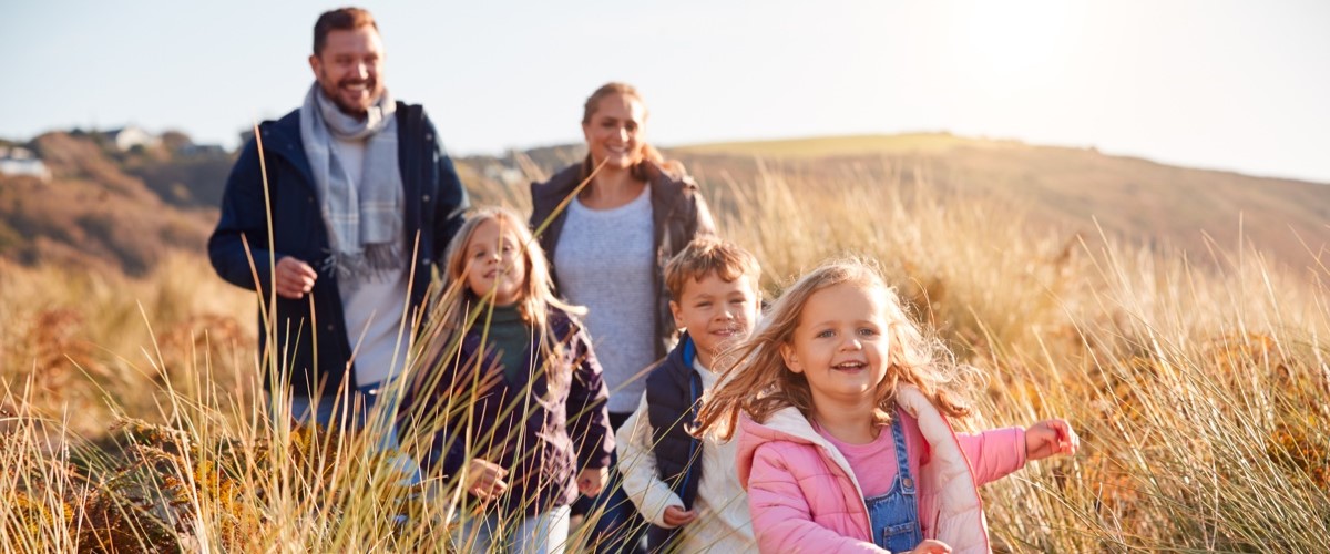 family on a walk in the long grass