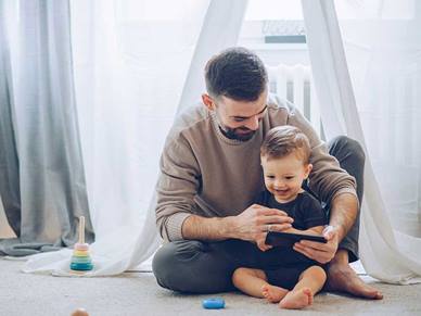 Father playing with his son on the floor