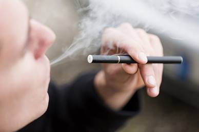 Close-up of a man smoking a vape 