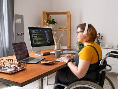Woman in wheelchair working from home