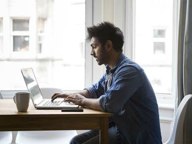 Man researching on a laptop
