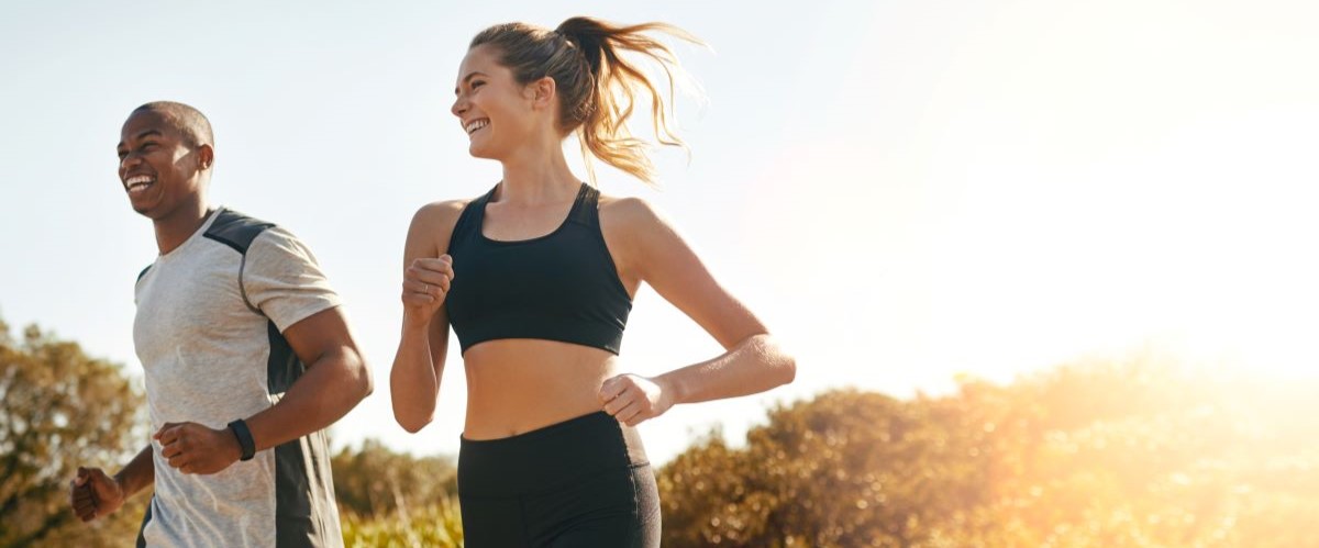 Woman man running smiling sunset countryside