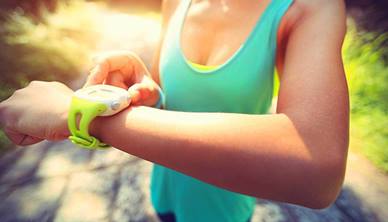 Woman looking at fitness tracker on her wrist
