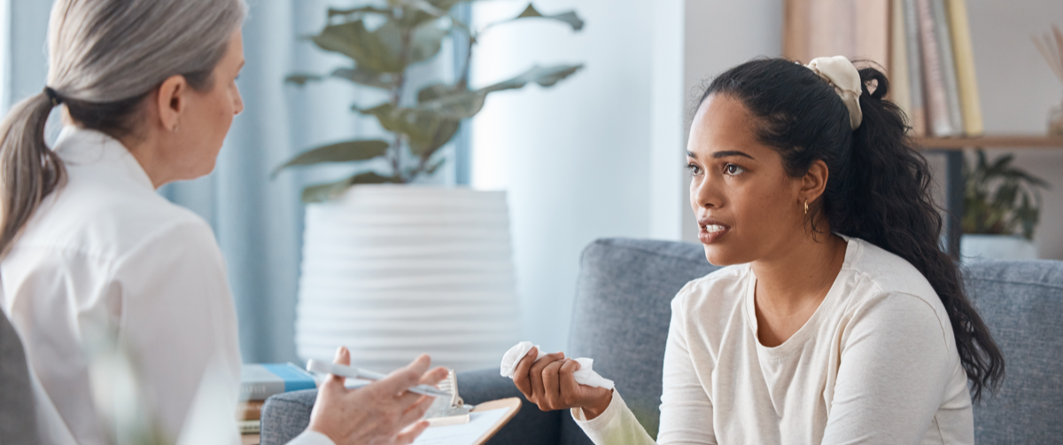 Shot of an attractive young woman sitting and talking to her psychologist during a consultation