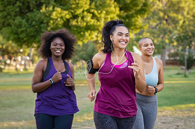 Three women running in park