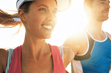 Woman and main running in sunshine